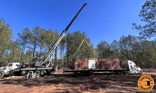 Crane lifting 20ft container on trailer.