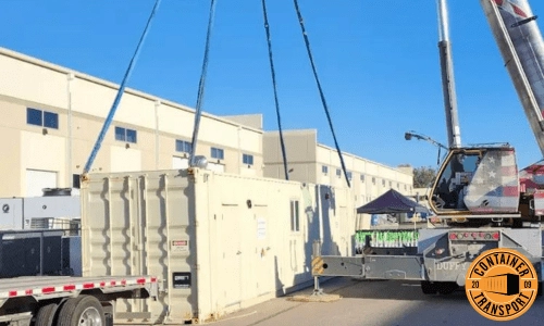 Crane lifting Container on a trailer for transport.