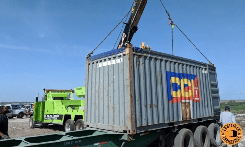 Crane loading Container on a trailer for transport.