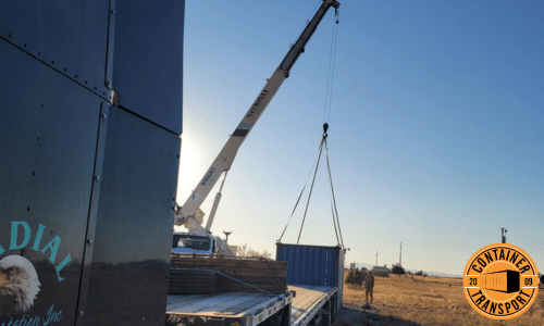 Crane lifting Container onto trailer.