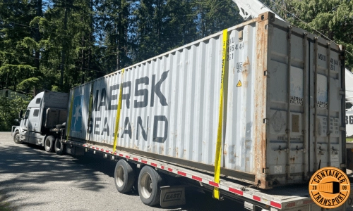 Shipping a Container strapped onto a step deck trailer.