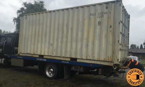 Strapping Container on a trailer for transport.