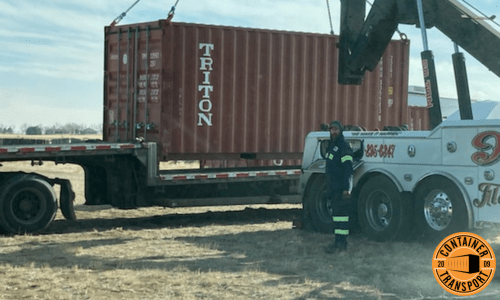 Crane unloading a Container on a trailer for transport.