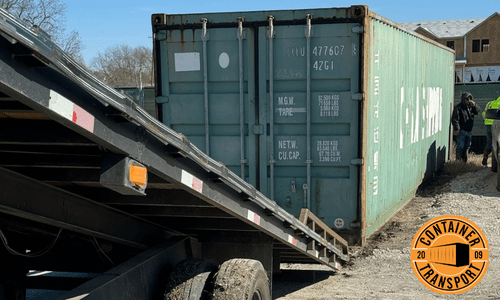 Green container being unloaded.