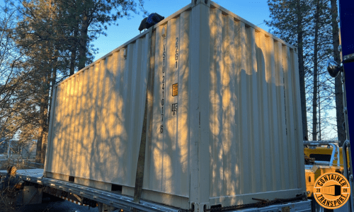 Container on a flatbed trailer for transport.