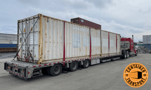 Container being transported on Step deck trailer.