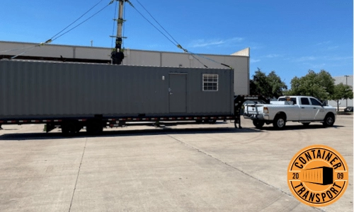 Portable office container being transported.