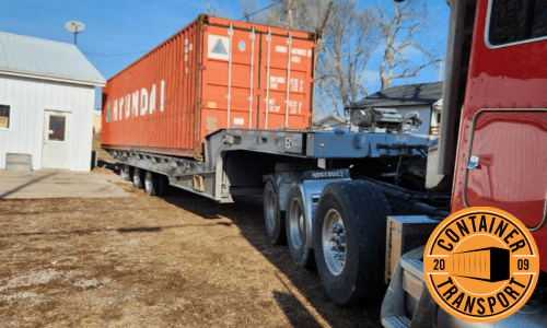 Transporting a container on a trailer.