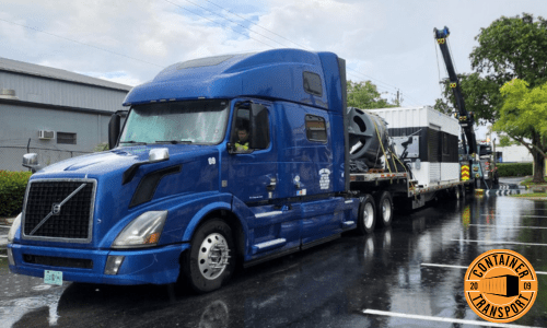 Crane loading container onto trailer.