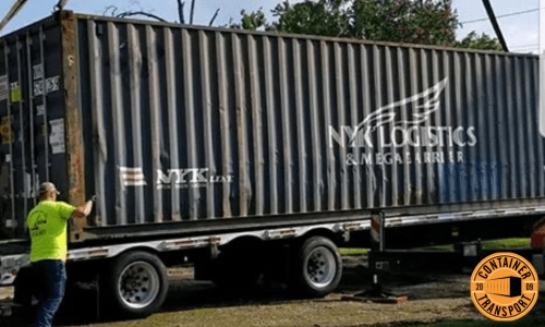 Crane lifting Container on a trailer.