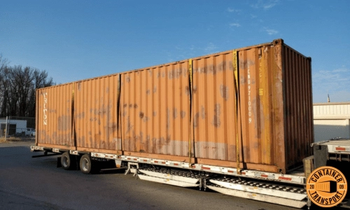 Shipping Container strapped onto a Step Deck trailer.