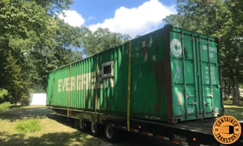 Shipping a Container strapped onto a Flatbed trailer.