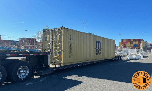 Transporting container strapped onto a RGN trailer.