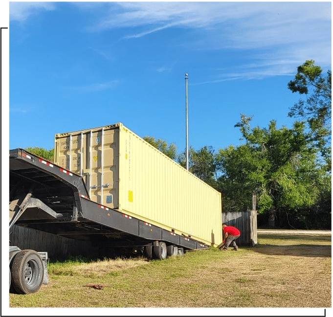 Unloading a container off a tilt trailer.