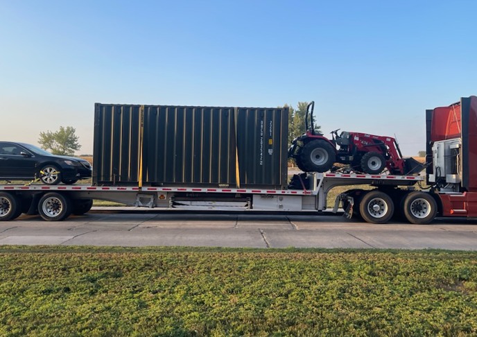 Transporting a container on a step deck trailer