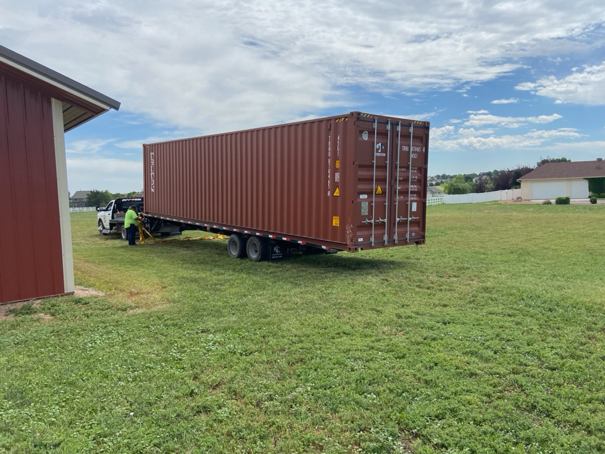 Securing an overweight container to a flatbed trailer.