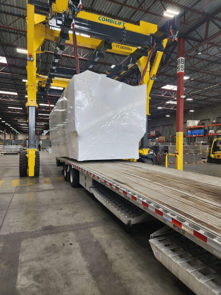 Transporting a covered container on a flatbed trailer.