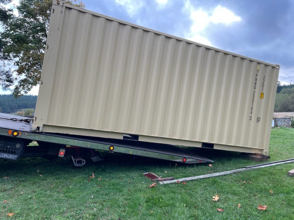 Container offloading from a tilt trailer.