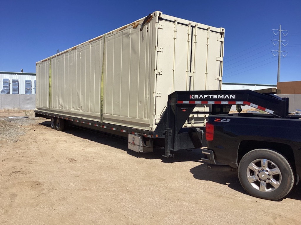 Container transported on a hot shot trailer.