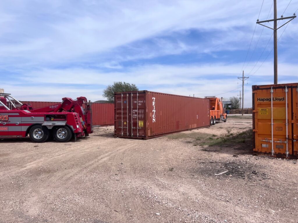 Safely offloading a container from a trailer.