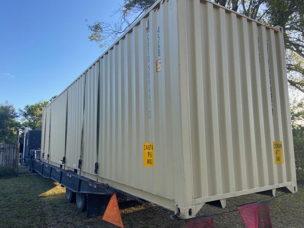 Container overhanging a trailer. 