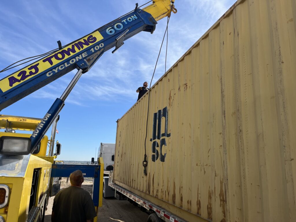 Lifting a container with a crane.