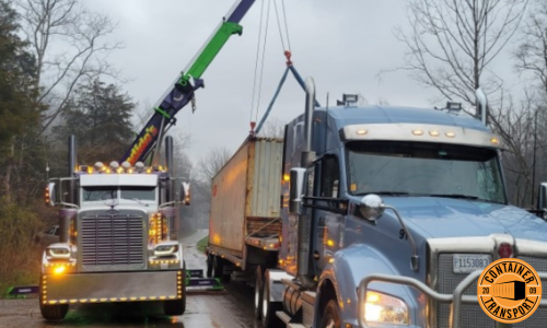 Crane unloading Container onto Trailer.