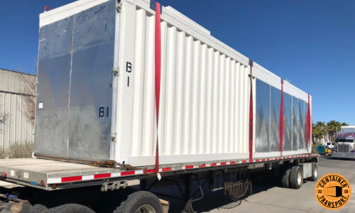 Container on a Flatbed trailer for transport.