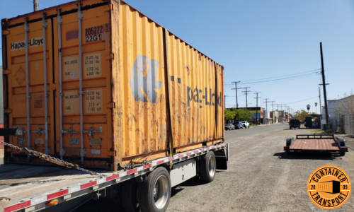 Transporting a Container strapped onto a trailer.