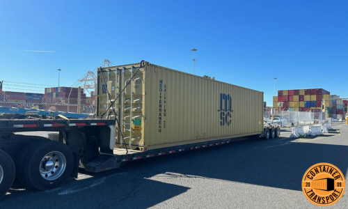 Transporting container strapped onto a RGN trailer.