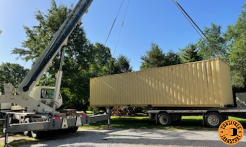 Crane lifting container on Trailer for transport.