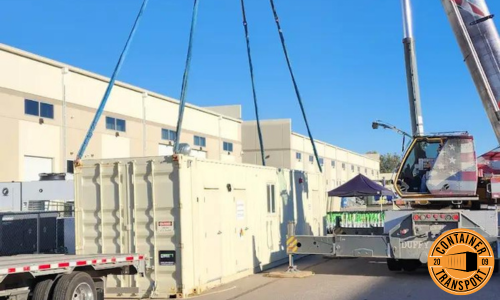 Crane lifting Container on a trailer for transport.