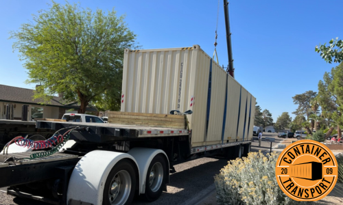 Crane putting container on a trailer.