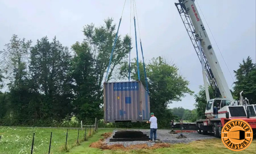 Crane unloading container onto the ground.