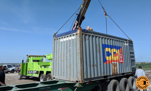 Crane loading Container on a trailer for transport.