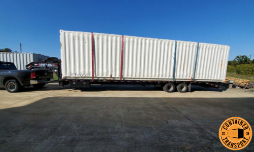 Container transported on a Gooseneck trailer.