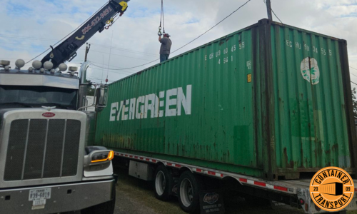 Crane loading a Container on a trailer for transport.