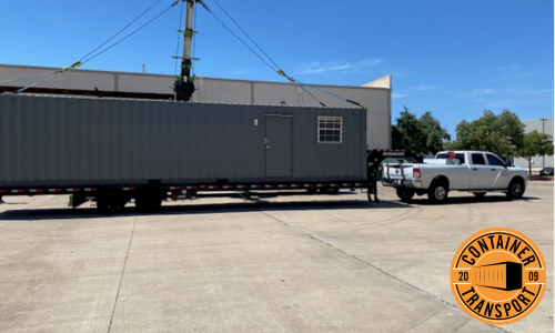 Portable office container being transported.