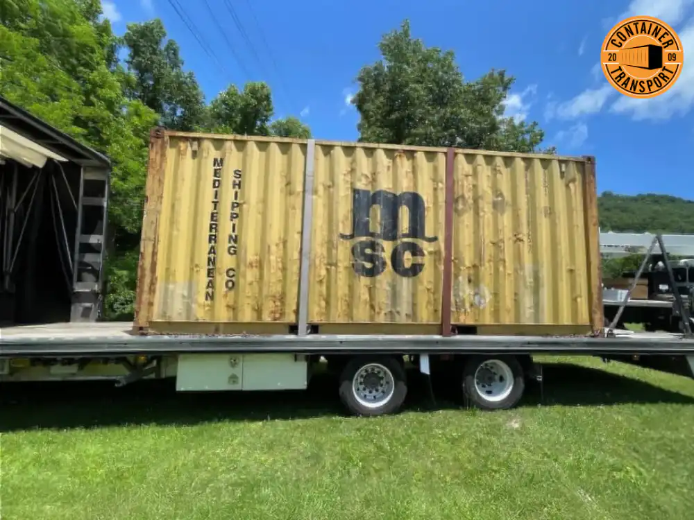 Container being loaded on grass